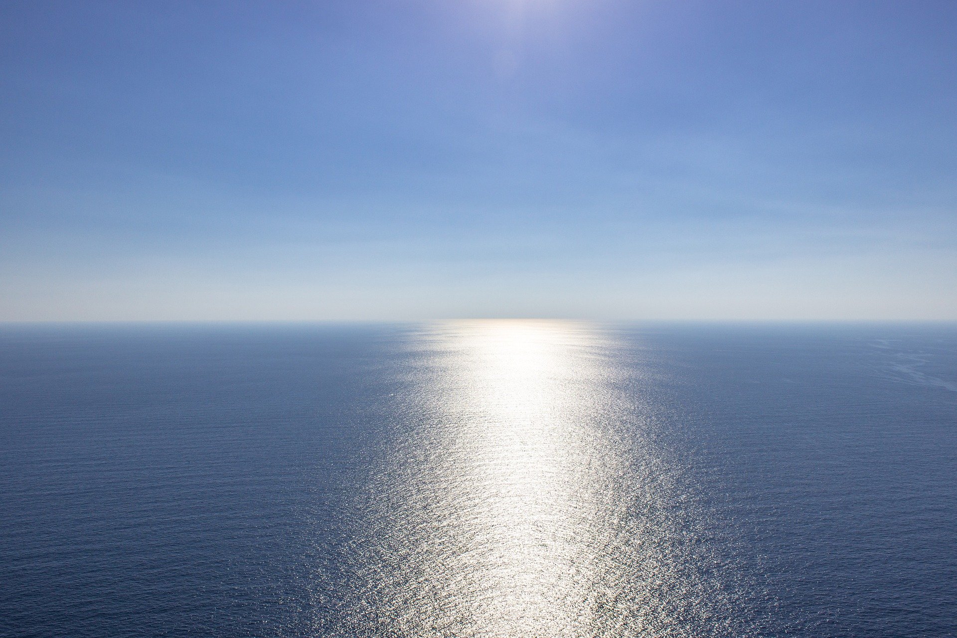 Blue ocean with reflecting sun