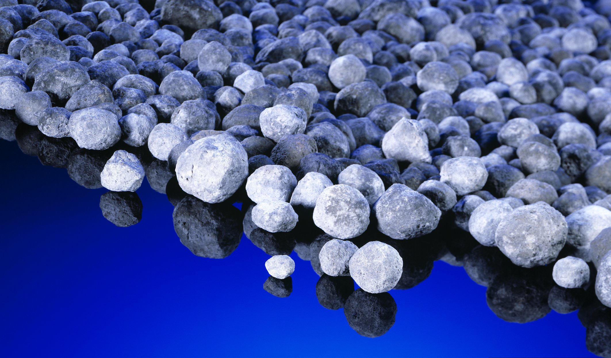Amorphous white-grey stones on a blue surface