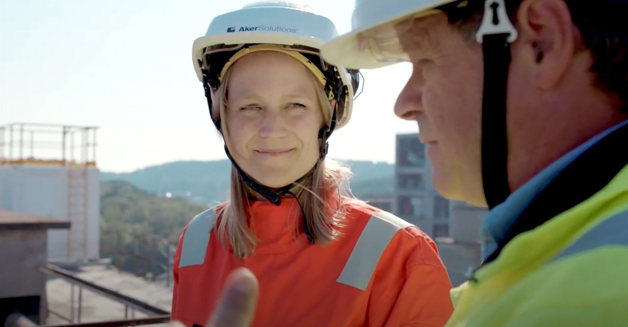 A woman with a helmet is looking at her conversation partner
