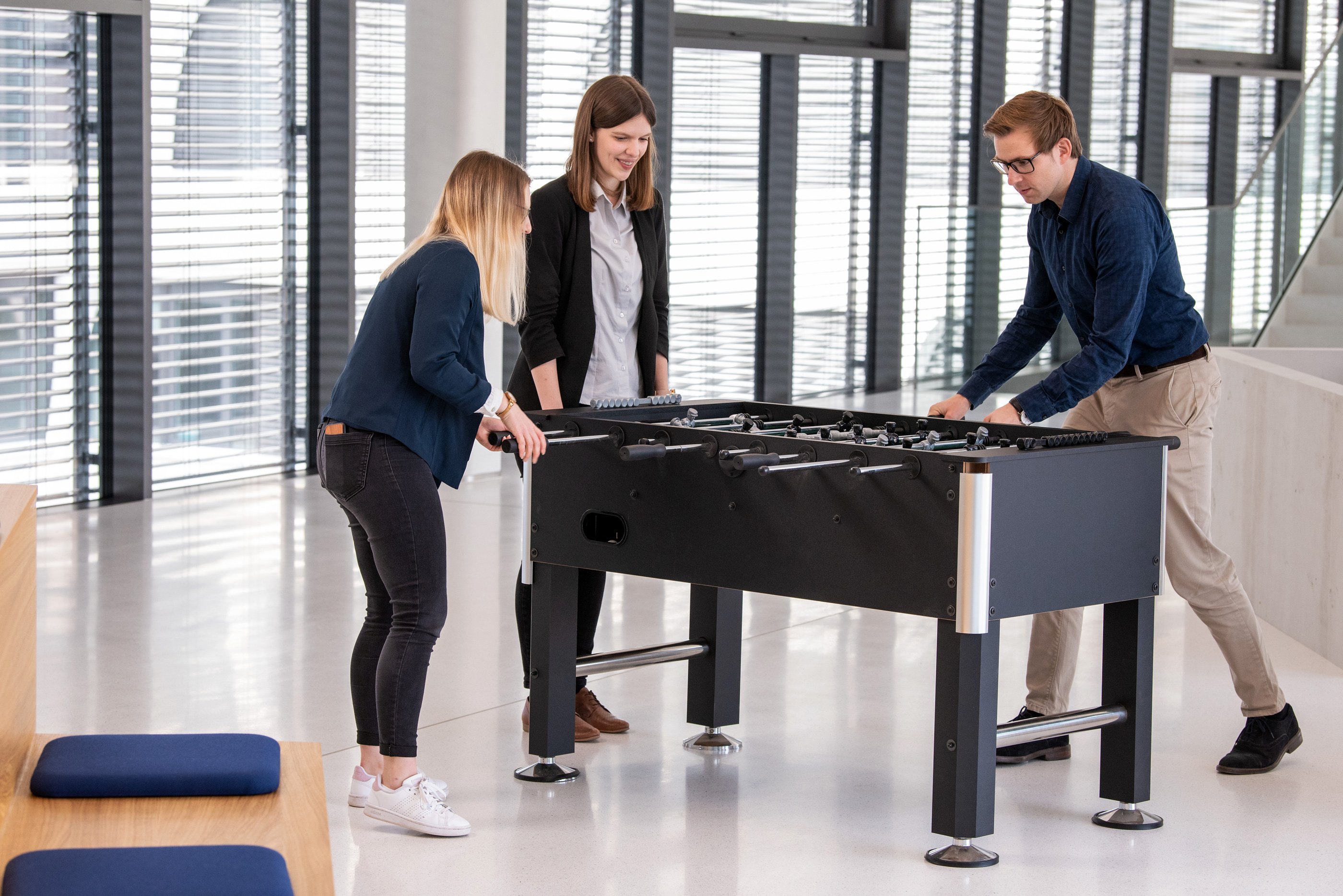 Three people playing table football