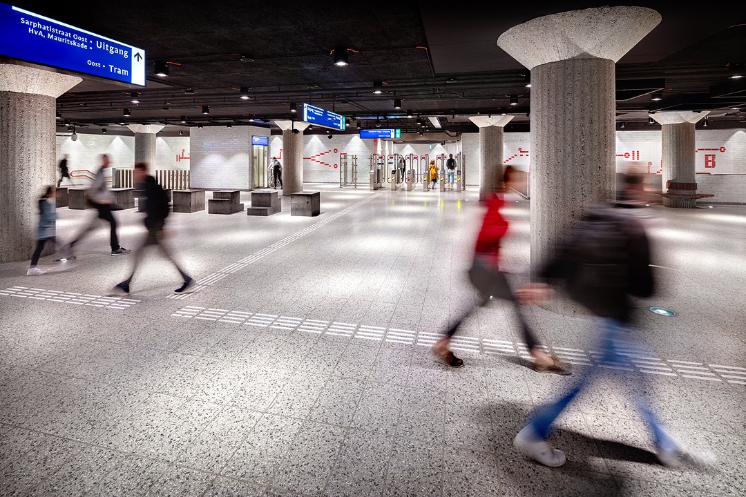 A modern underground metro with concrete pillars