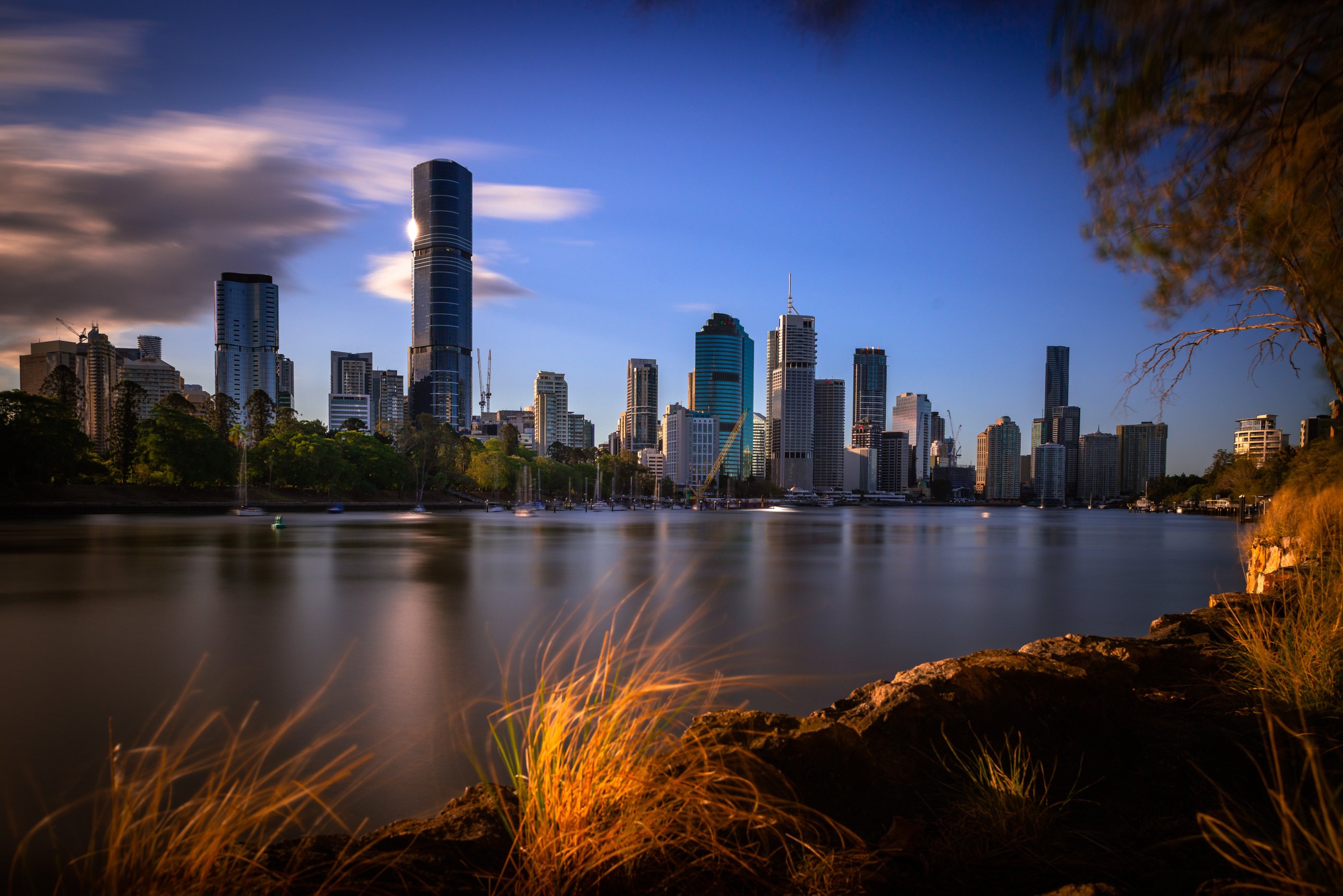 The Brisbane skyline besides a river