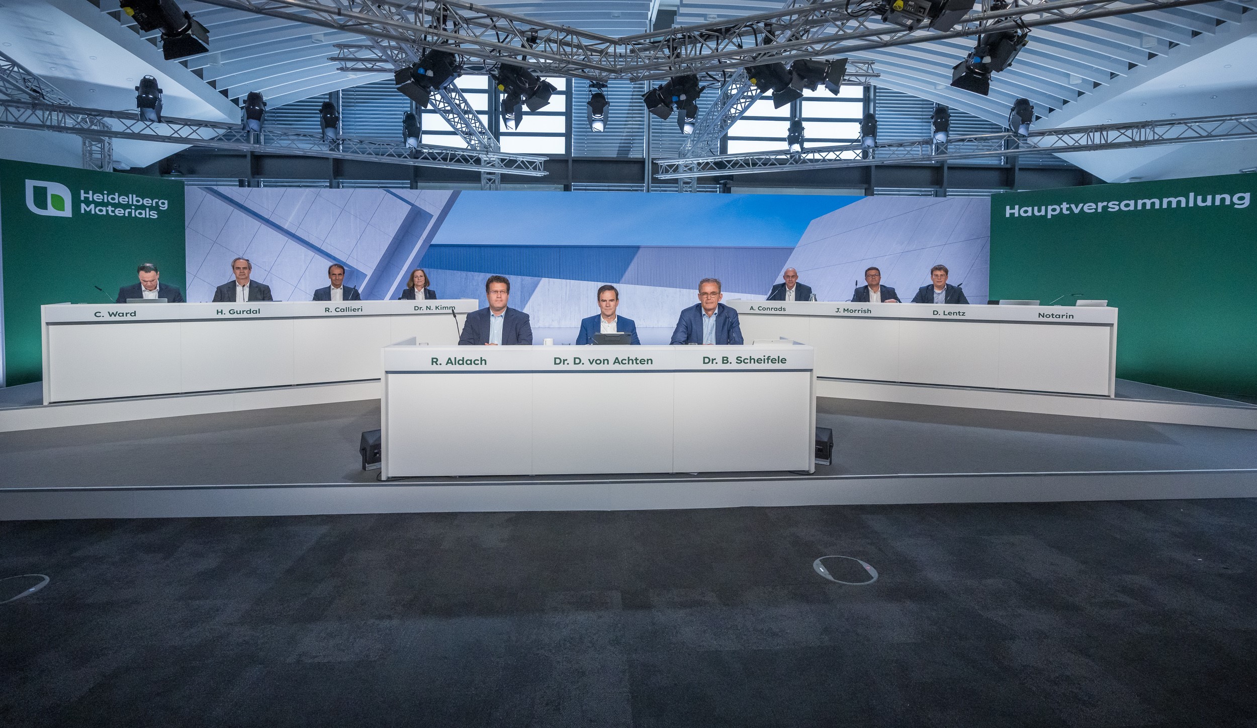 Members of the Executive Board and Supervisory Board sitting on a stage