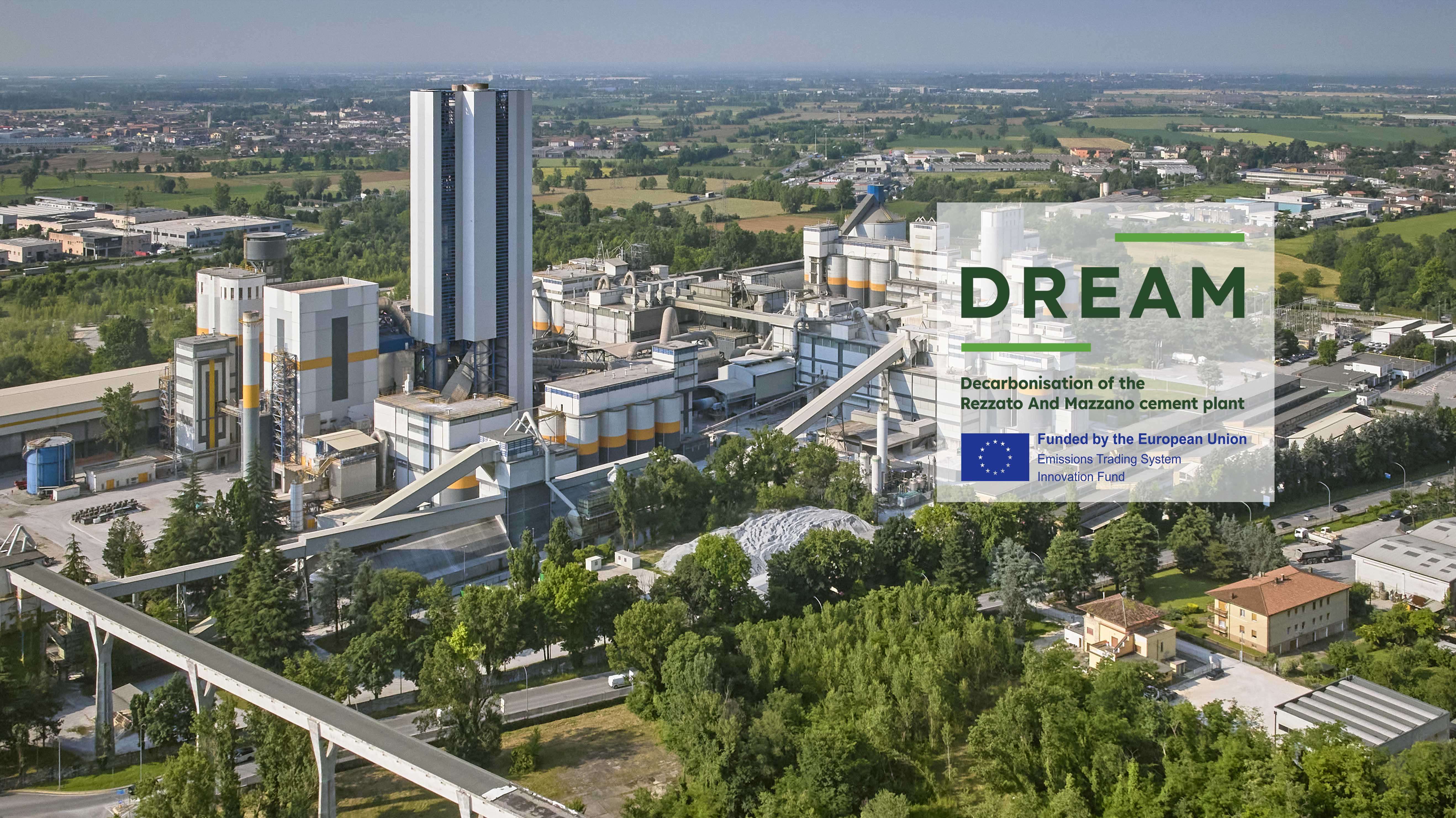 A cement plant surrounded by greenery, with the DREAM project logo prominently displayed.