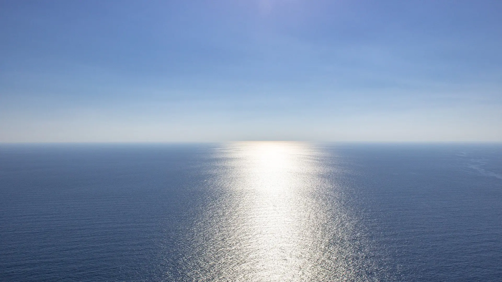 Blue ocean with reflecting sun