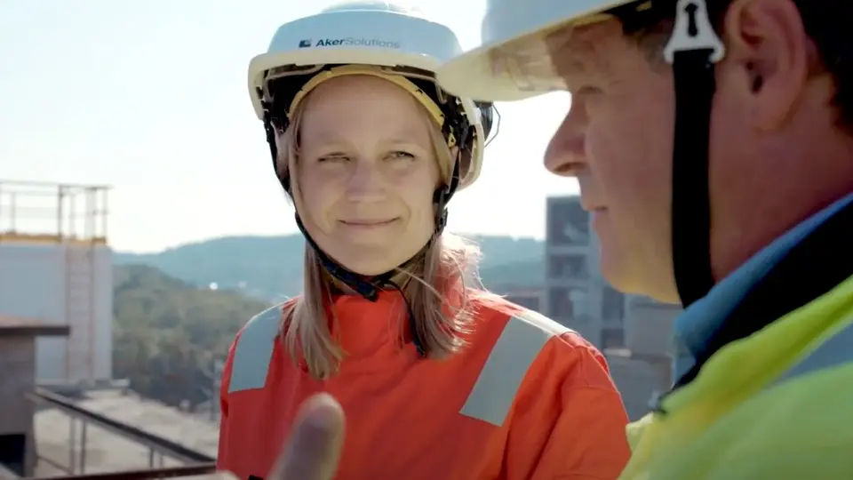 A woman with a helmet is looking at her conversation partner