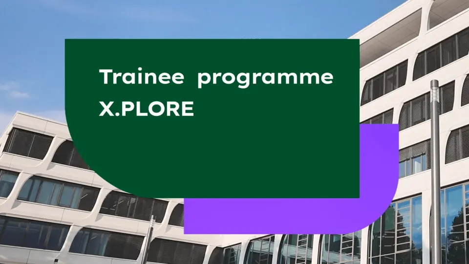 Green and purple graphic overlay with the text "Trainee programme X.PLORE" against a background of a modern white building with curved windows and blue sky.