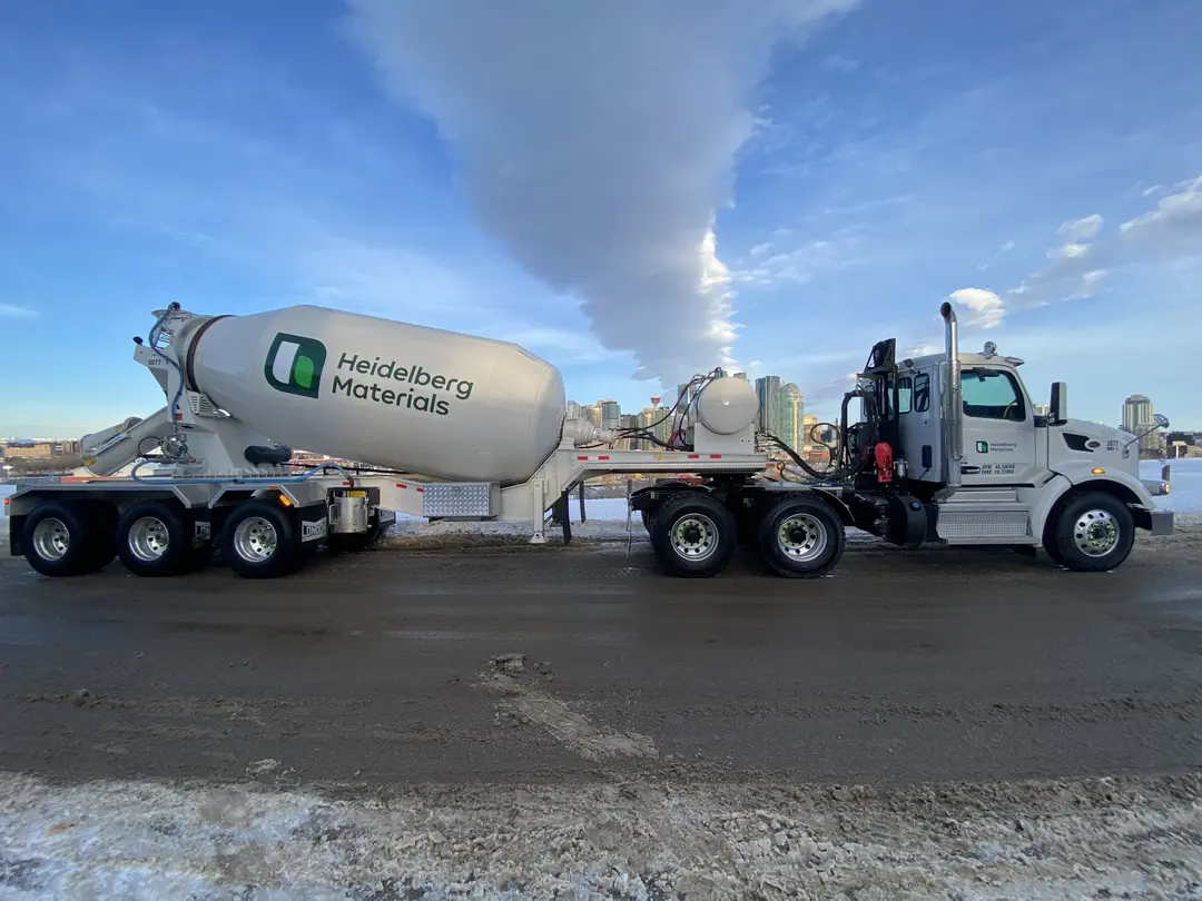 Betonmischfahrzeug mit Heidelberg-Materials-Logo auf verschneitem Boden