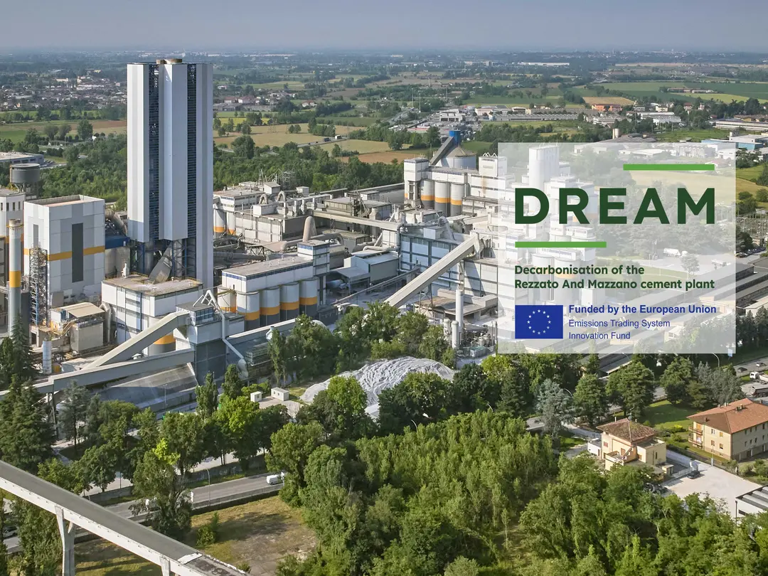 A cement plant surrounded by greenery, with the DREAM project logo prominently displayed.