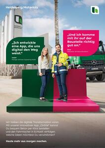 IT and sales employees on stage in front of a ready-mix concrete plant