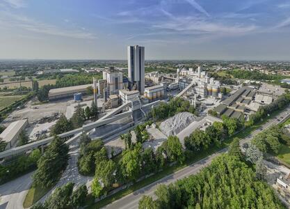 Aerial view of a cement plant surrounded by greenery.