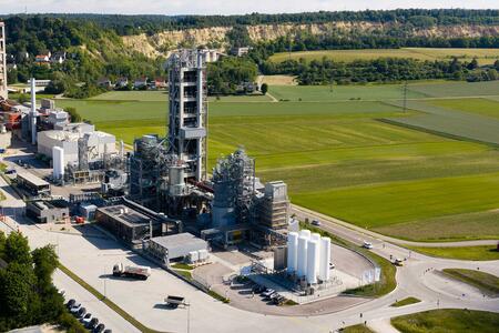 An industrial facility surrounded by green fields.