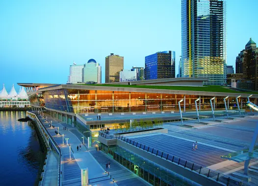 Flat building on the waterfront in front of high-rise buildings