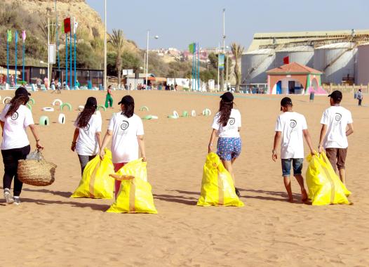People with yellow bags on the beach