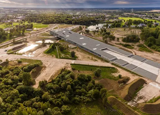 An elongated building with a flat roof in the middle of a mining area