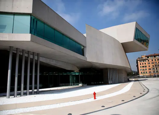 Contemporary art museum featuring a unique concrete design and a plaza with a red fire hydrant.