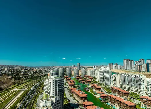Aerial view of a modern city with high-rise buildings and a network of canals.